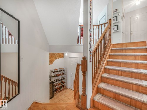 The property features a staircase with wood treads and risers, complemented by a wooden banister - 308 Beringer Crescent, Edmonton, AB - Indoor Photo Showing Other Room