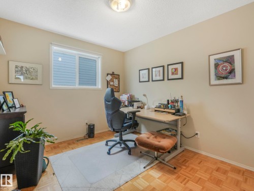 This room features wood parquet flooring, a white window frame, and neutral-toned walls - 308 Beringer Crescent, Edmonton, AB - Indoor Photo Showing Office