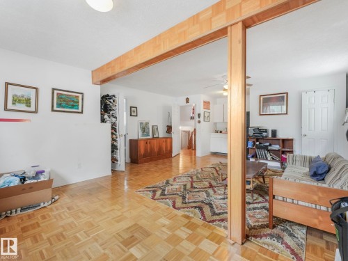 This interior space features parquet flooring, white walls, and a wood-toned structural beam - 308 Beringer Crescent, Edmonton, AB - Indoor