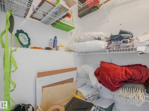 This storage area features white walls and wire shelving, providing functional organization - 308 Beringer Crescent, Edmonton, AB - 