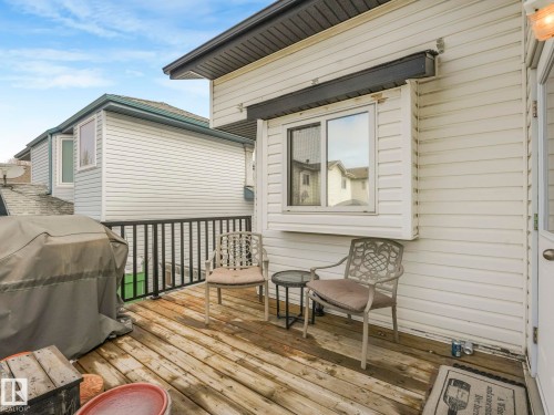 The property features a wooden deck with a black railing, providing outdoor space - 308 Beringer Crescent, Edmonton, AB - Outdoor With Deck Patio Veranda With Exterior