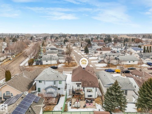 Aerial view of the property with a brown roof and a backyard deck, situated within a residential neighborhood featuring several other properties with grey roofs - 308 Beringer Crescent, Edmonton, AB - Outdoor With View