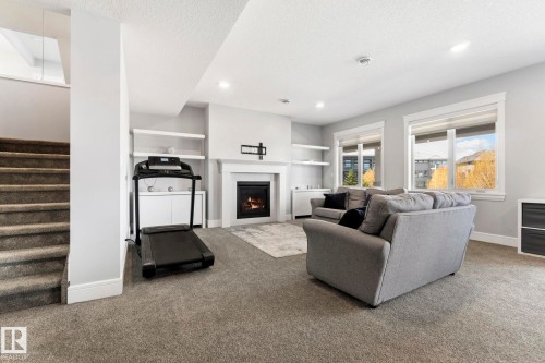 4412 Wingfield Cape, Edmonton, AB - Indoor Photo Showing Other Room With Fireplace