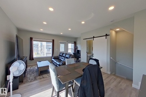 Open-concept living area featuring recessed lighting and wood-finish flooring - 33 150 Everitt Dr, St. Albert, AB - Indoor Photo Showing Dining Room