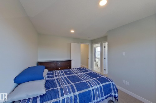 Bedroom space featuring light gray walls, recessed lighting, and carpet flooring - 33 150 Everitt Dr, St. Albert, AB - Indoor Photo Showing Bedroom