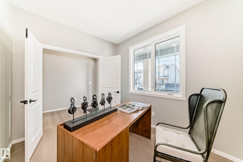 Bright room with wood-finish flooring, a large window, and a white trim package - 1603 206 Street, Edmonton, AB - Indoor