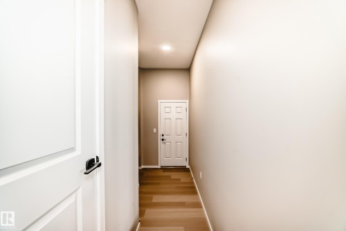Hallway with wood-finish flooring, light neutral walls, and a recessed ceiling light - 1603 206 Street, Edmonton, AB - Indoor Photo Showing Other Room