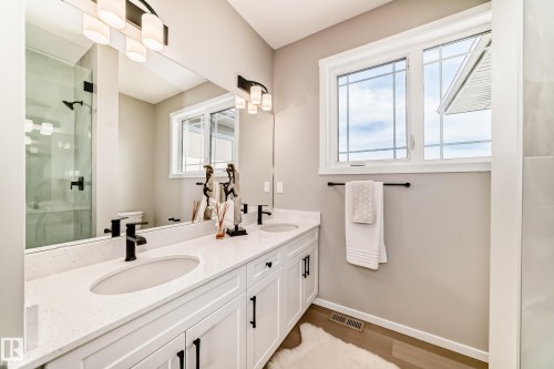 Double vanity with white cabinetry and quartz countertops, featuring matte black hardware - 1603 206 Street, Edmonton, AB - Indoor Photo Showing Bathroom