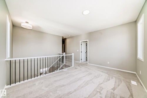 Carpeted landing featuring a white railing with black balusters, recessed lighting, and a drum-style ceiling light - 1603 206 Street, Edmonton, AB - Indoor Photo Showing Other Room
