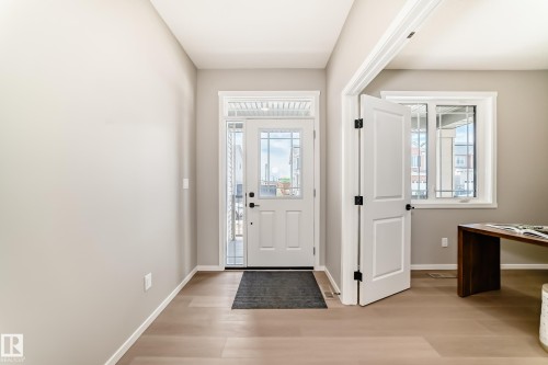 Entryway featuring a glass-paneled door, transom window, and sidelights - 1603 206 Street, Edmonton, AB - Indoor Photo Showing Other Room