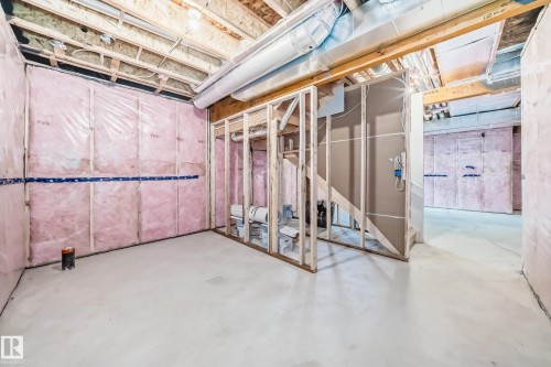 Unfinished lower level featuring exposed wood framing, ceiling joists, and ductwork - 1603 206 Street, Edmonton, AB - Indoor Photo Showing Basement