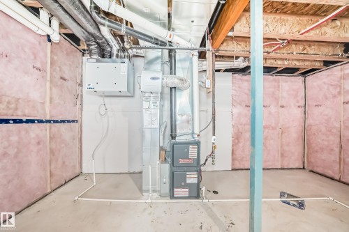 Utility room featuring a furnace, water heater, and exposed ceiling joists - 1603 206 Street, Edmonton, AB - Indoor Photo Showing Basement