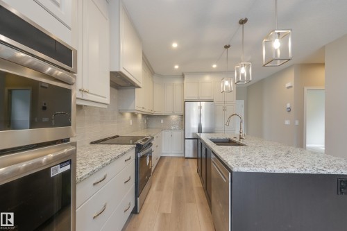 209 Stonehouse Way, Leduc, AB - Indoor Photo Showing Kitchen With Upgraded Kitchen