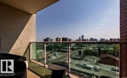 Private balcony featuring a glass railing system and a brick-finish exterior wall - 