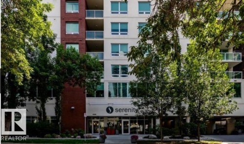 Modern multi-story building featuring a prominent street-level entrance - 702 10055 118 Street, Edmonton, AB - Outdoor With Balcony With Facade