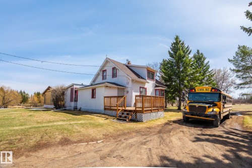 White exterior with red trim accents and a gabled roofline - A & B, 4858 Centre St, New Sarepta, AB - Outdoor