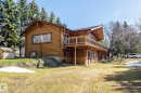 Rustic log cabin exterior with a full-length second-story balcony - A & B, 4858 Centre St, New Sarepta, AB  - Outdoor 