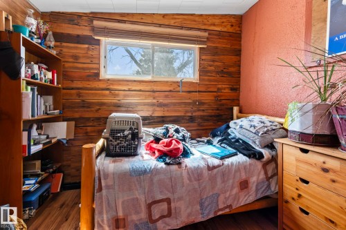 Wood-paneled wall with a window featuring blinds - A & B, 4858 Centre St, New Sarepta, AB - Indoor