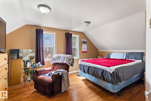 Room with pitched ceilings, two windows, and wood-finish flooring - A & B, 4858 Centre St, New Sarepta, AB - Indoor Photo Showing Bedroom