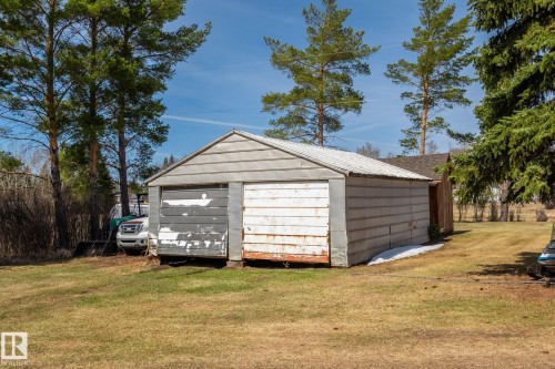 Detached two-car garage with horizontal siding and a gambrel-style roof - A & B, 4858 Centre St, New Sarepta, AB - Outdoor