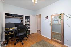 Room featuring wood-finish flooring, light blue walls, and a ceiling fan with integrated lighting - 