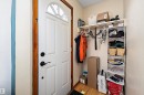 Entryway featuring a white paneled door with an arched top window, dark hardware, and natural wood trim - 11607 141 Street, Edmonton, AB  - Indoor Photo Showing Other Room 
