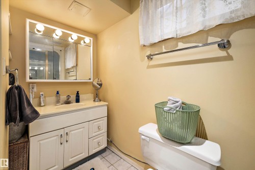 Bathroom featuring a vanity with a light-colored countertop, integrated sink, and white cabinetry - 11607 141 Street, Edmonton, AB - Indoor Photo Showing Bathroom