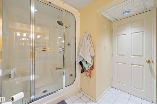 Shower enclosure with clear glass doors and chrome hardware - 11607 141 Street, Edmonton, AB - Indoor Photo Showing Bathroom
