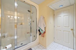 Shower enclosure with clear glass doors and chrome hardware - 
