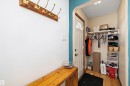 Entryway featuring wood-finish flooring and a built-in coat rack with brass hooks - 11607 141 Street, Edmonton, AB  - Indoor Photo Showing Other Room 
