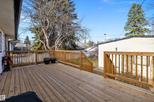 Spacious wood deck with natural wood railings, offering direct access to the yard - 11607 141 Street, Edmonton, AB - Outdoor With Deck Patio Veranda With Exterior