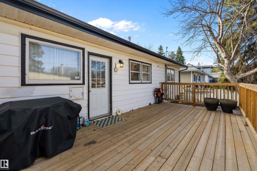 Expansive wood deck with a full wood railing system, providing outdoor living space - 11607 141 Street, Edmonton, AB - Outdoor With Deck Patio Veranda With Exterior