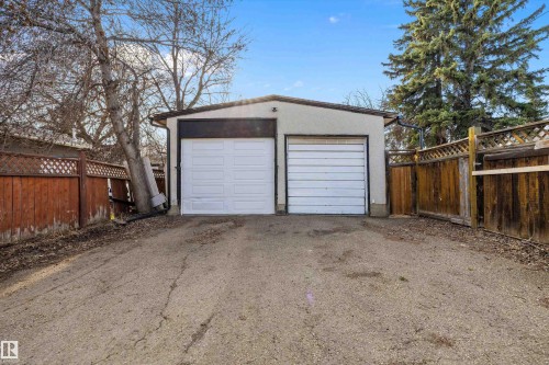 Detached two-car garage with white panel doors and stucco exterior - 11607 141 Street, Edmonton, AB - Outdoor