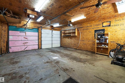 Two-car garage featuring concrete flooring, exposed wood-panel walls, and an exposed wood-panel ceiling - 11607 141 Street, Edmonton, AB - Indoor Photo Showing Garage