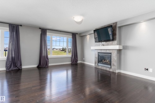 3318 21A Avenue, Edmonton, AB - Indoor Photo Showing Living Room With Fireplace