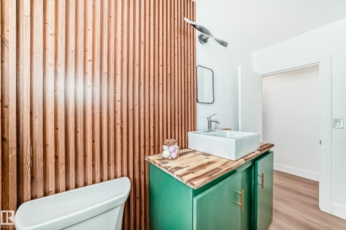 Vertical wood slat wall paneling in a natural finish - 8712 89 Avenue, Edmonton, AB 