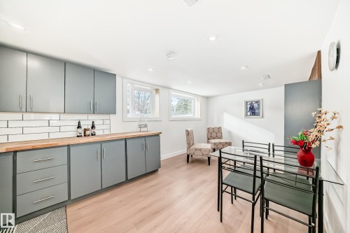 Modern kitchen area with light wood-finish flooring - 8712 89 Avenue, Edmonton, AB 