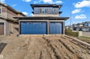 Contemporary home featuring a two-car garage with blue sectional doors - 12603 44 Street, Edmonton, AB  - Outdoor 