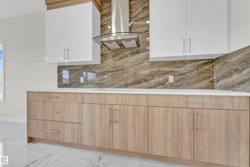 Kitchen featuring two-tone cabinetry with light wood-finish lower cabinets and white upper cabinets - 12603 44 Street, Edmonton, AB - Indoor