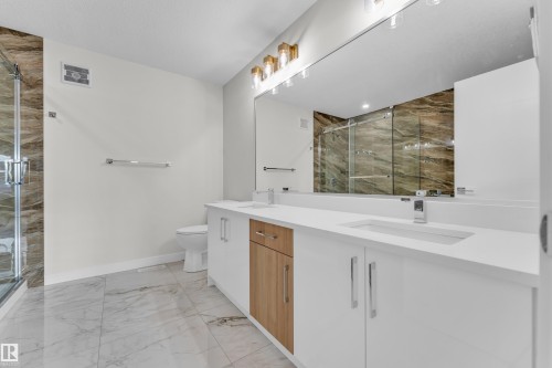 Dual vanity with integrated sinks and white countertops - 12603 44 Street, Edmonton, AB - Indoor Photo Showing Bathroom