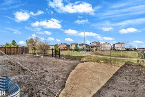 Property features a spacious lot with a chain-link fence bordering a community green space - 12603 44 Street, Edmonton, AB - Outdoor With View