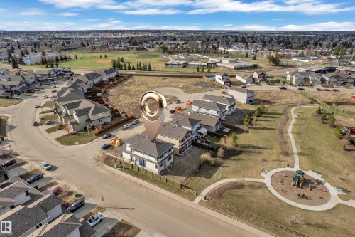 Aerial perspective highlighting a residential property with light-colored siding and dark roofing, situated on a corner lot - 12603 44 Street, Edmonton, AB - Outdoor With View