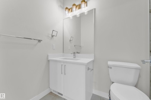 Modern vanity featuring a white countertop and integrated sink - 12603 44 Street, Edmonton, AB - Indoor Photo Showing Bathroom