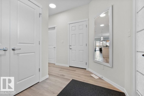 Entryway featuring wood-finish flooring, recessed lighting, and white paneled doors - 3623 6 Street, Edmonton, AB - Indoor Photo Showing Other Room