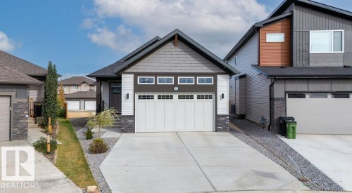 Modern facade featuring a shingled gable roof, horizontal siding, stone accents, a two-car garage, and a concrete driveway - 3623 6 Street, Edmonton, AB - Outdoor With Facade