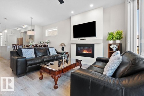 Open-concept living area featuring light wood-finish flooring and recessed lighting - 3623 6 Street, Edmonton, AB - Indoor Photo Showing Living Room With Fireplace