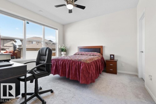Room featuring light-toned carpeting and a ceiling fan with integrated lighting - 3623 6 Street, Edmonton, AB - Indoor Photo Showing Bedroom
