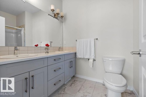 Double vanity with undermount sinks, light gray cabinetry, and a light-toned countertop - 3623 6 Street, Edmonton, AB - Indoor Photo Showing Bathroom