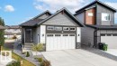 Modern exterior featuring mixed siding, a two-car garage with panel windows, a concrete driveway, and established landscaping - 3623 6 Street, Edmonton, AB  - Outdoor With Facade 