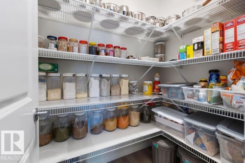 Walk-in pantry featuring white wire shelving, L-shaped configuration, and light-toned flooring - 3623 6 Street, Edmonton, AB - Indoor With Storage
